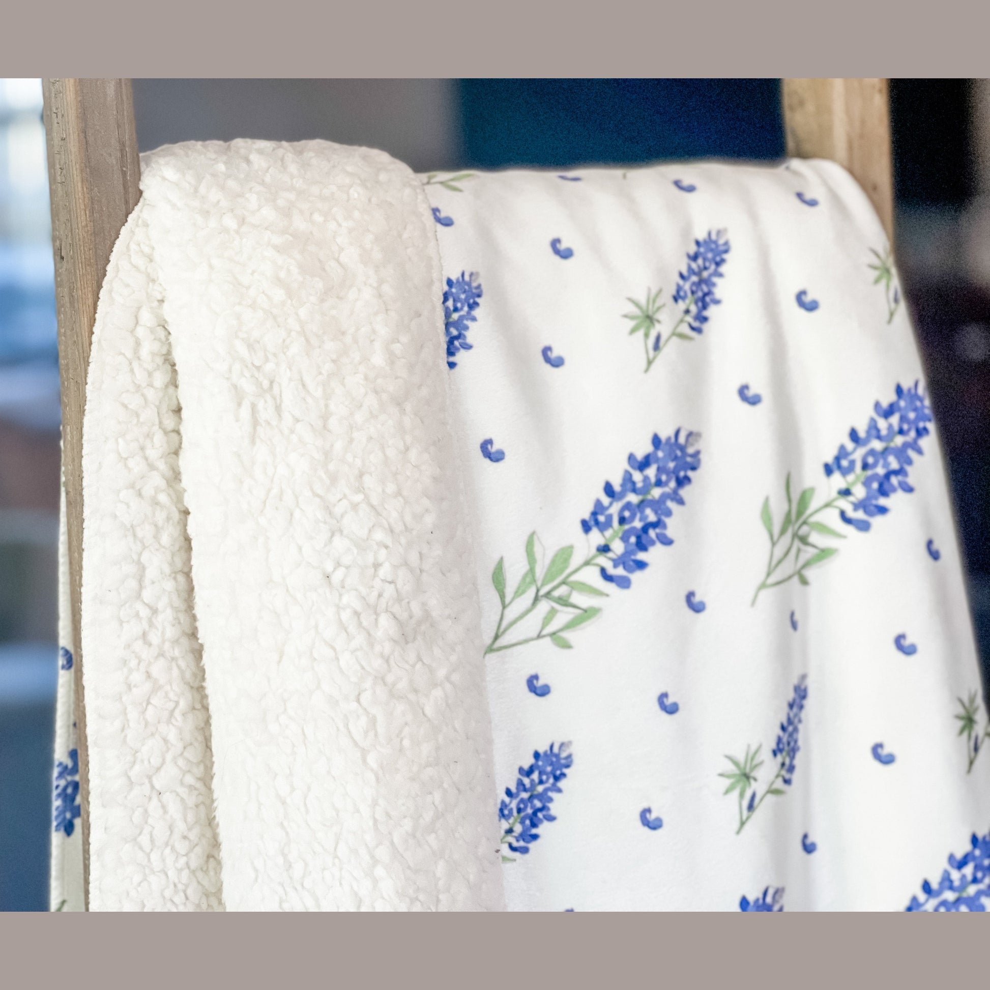 Soft plush throw blanket with vibrant bluebonnet flowers on a white background, measuring 60x80 inches.