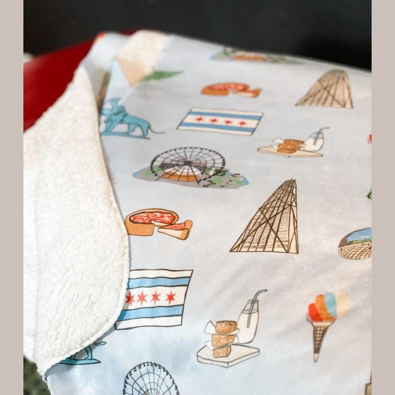 Cozy Chicago-themed plush throw blanket with iconic skyline and landmarks, 60x80 inches, vibrant colors.