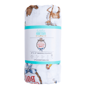 Country Boy muslin swaddle blanket with a playful farm animal print, featuring cows, pigs, and tractors.