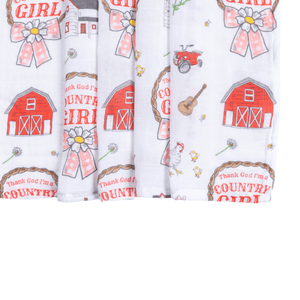 Muslin swaddle blanket with a country girl theme, featuring floral patterns and pastel colors.