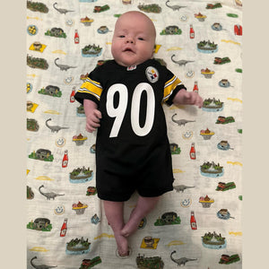 Pittsburgh-themed baby gift set with muslin swaddle blanket, burp cloth, and bib featuring city landmarks.