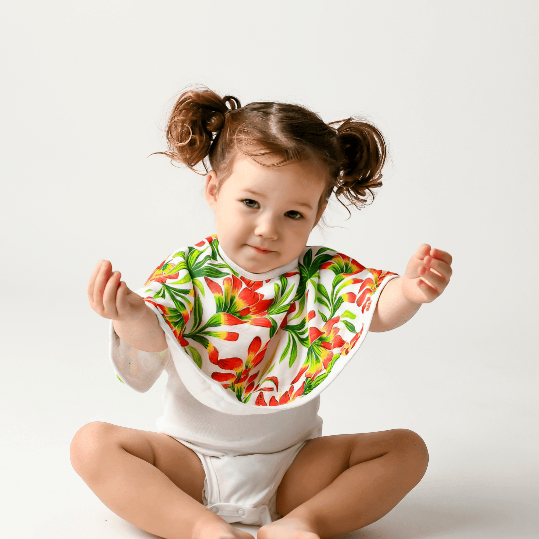 2-in-1 burp cloth and bib combo with a prairie fire pattern, featuring vibrant red and yellow floral designs.