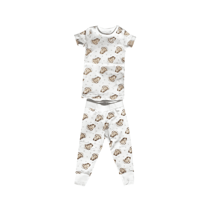 Toddler wearing "Aw Shucks" oyster-themed pajamas, smiling and holding a toy oyster, on a white background.