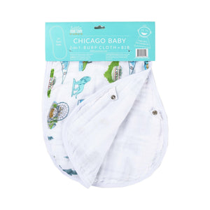 White baby bib and burp cloth set featuring a colorful Chicago skyline and landmarks illustration.