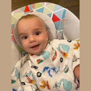 Baby burp cloth and wraparound bib set with Michigan-themed design, featuring state icons and landmarks.