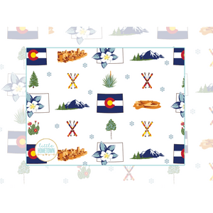 Cozy Colorado-themed plush throw blanket with mountain and forest design, featuring skis, mountains, Mesa Verde, trees, flowers, and the state flag