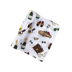 Baby swaddle blanket with a playful pattern of bow ties, mustaches, and glasses on a white background.