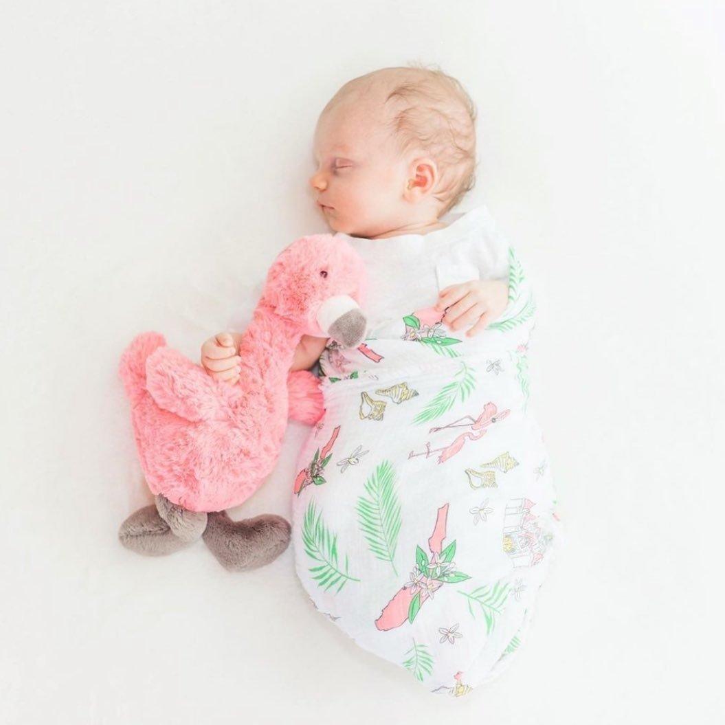 White muslin swaddle blanket with colorful floral patterns, featuring pink, yellow, and green flowers.