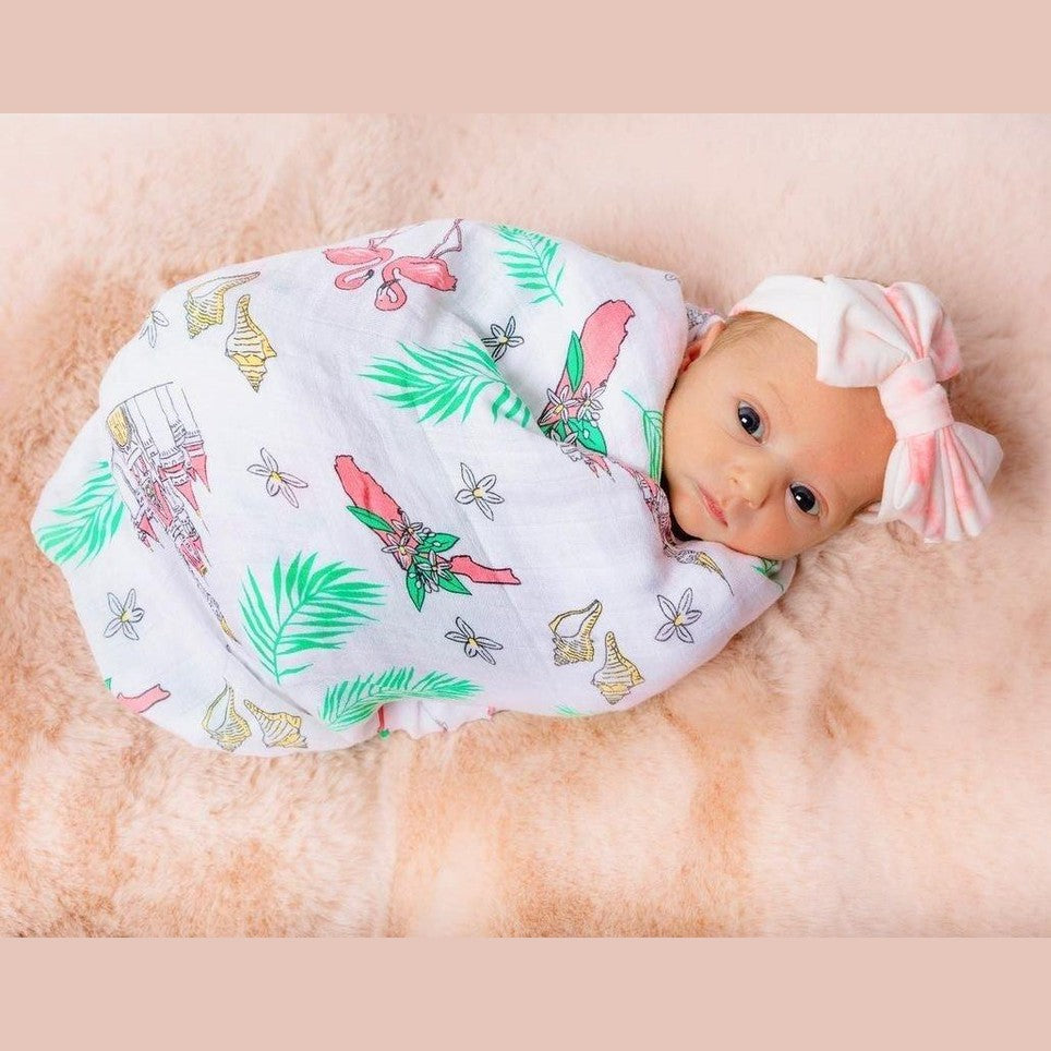 Floral baby muslin swaddle blanket with pink, yellow, and green flowers on a white background, by Little Hometown.