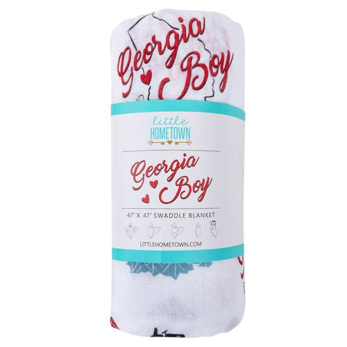 Baby swaddled in a white muslin blanket with 