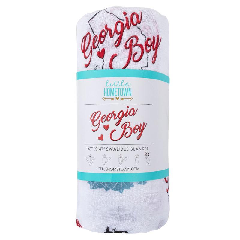 Baby swaddled in a white muslin blanket with 