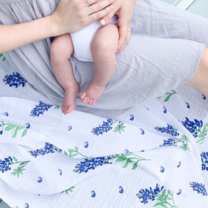 Bluebonnet-themed baby muslin swaddle blanket and burp cloth set, featuring delicate floral patterns on soft fabric.