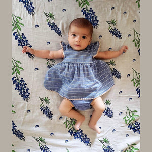 Bluebonnet-themed baby muslin swaddle blanket and burp cloth set, featuring delicate floral patterns on soft fabric.