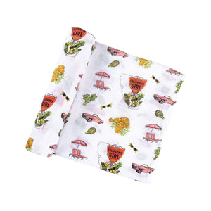 Gift set with "California Girl" muslin swaddle blanket and matching burp cloth/bib combo in pastel colors.