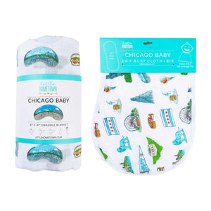 Chicago-themed baby gift set with muslin swaddle blanket and burp cloth/bib combo, featuring city landmarks.