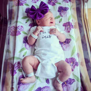 Gift set with baby muslin swaddle blanket and burp cloth, featuring a delicate irises floral pattern.