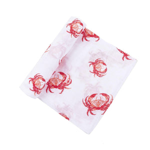 Pink crab-themed baby muslin swaddle blanket and burp cloth set, neatly folded on a white background.