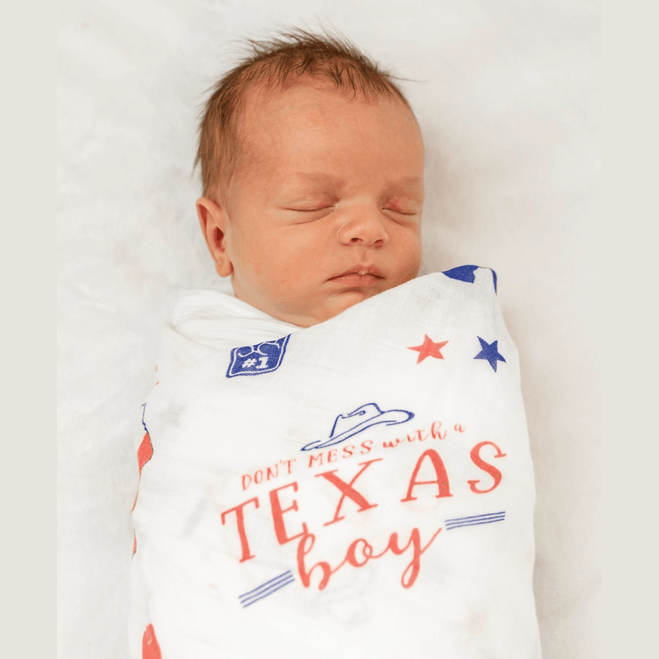 Texas-themed baby gift set with a muslin swaddle blanket and burp cloth, featuring blue and white designs.