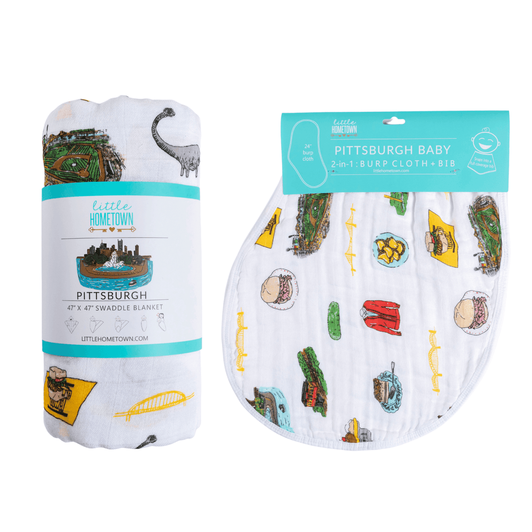 Pittsburgh-themed baby gift set with a muslin swaddle blanket and burp cloth, featuring city landmarks and icons.