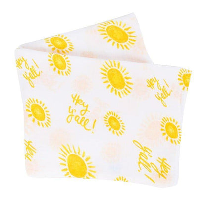 White muslin swaddle blanket with "Hey Y'all" text in playful script, featuring blue and yellow accents.