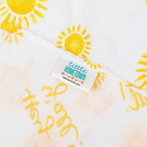 White muslin swaddle blanket with "Hey Y'all" text in playful script, featuring pastel-colored stars and hearts.