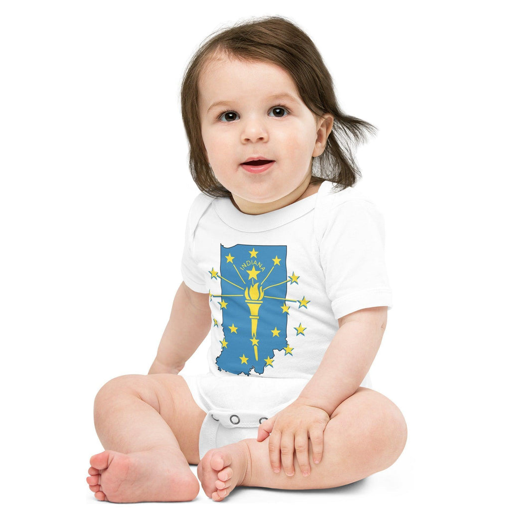 White baby onesie featuring a blue outline of Indiana state, with a yellow torch and stars and the word 