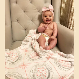 Louisiana-themed baby girl muslin swaddle blanket with pink and white design, featuring state icons and "Louisiana" text.