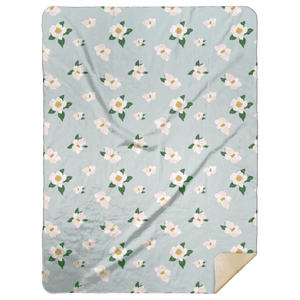 Soft, cozy throw blanket with magnolia flower design in pastel colors, measuring 60x80 inches.