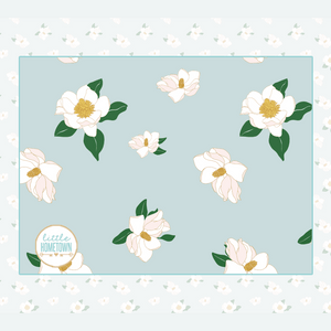 Soft, plush throw blanket with a magnolia flower pattern in pastel colors, measuring 60x80 inches.