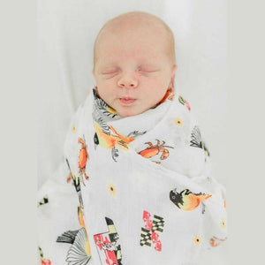 White muslin swaddle blanket with Maryland-themed illustrations, including crabs, flags, and landmarks.