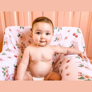 White muslin swaddle blanket with colorful floral patterns and "Michigan Baby" text, neatly folded on a white background.