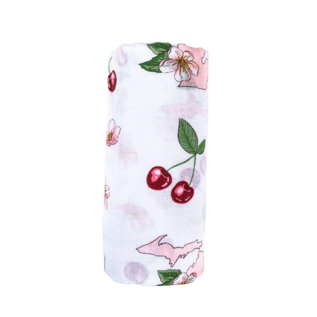 White muslin swaddle blanket with colorful floral patterns and "Michigan" text, laid flat on a white background.