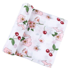 White muslin swaddle blanket with colorful floral patterns and "Michigan Baby" text, laid flat on a white background.