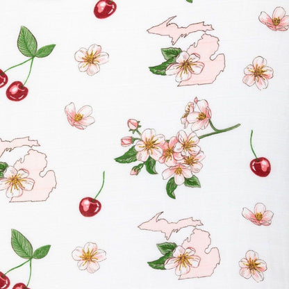 White muslin swaddle blanket with colorful floral patterns and "Michigan Baby" text, laid flat on a white background.