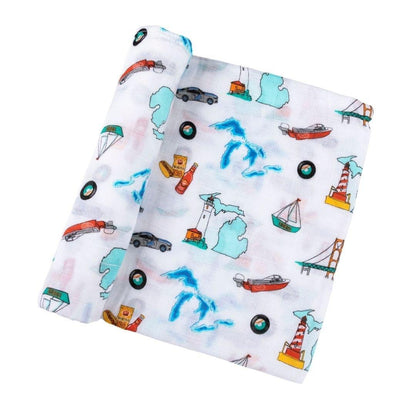 White muslin swaddle blanket with blue Michigan state map, featuring landmarks and icons, on a white background.