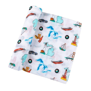 White muslin swaddle blanket with blue Michigan state map, featuring landmarks and icons, on a white background.