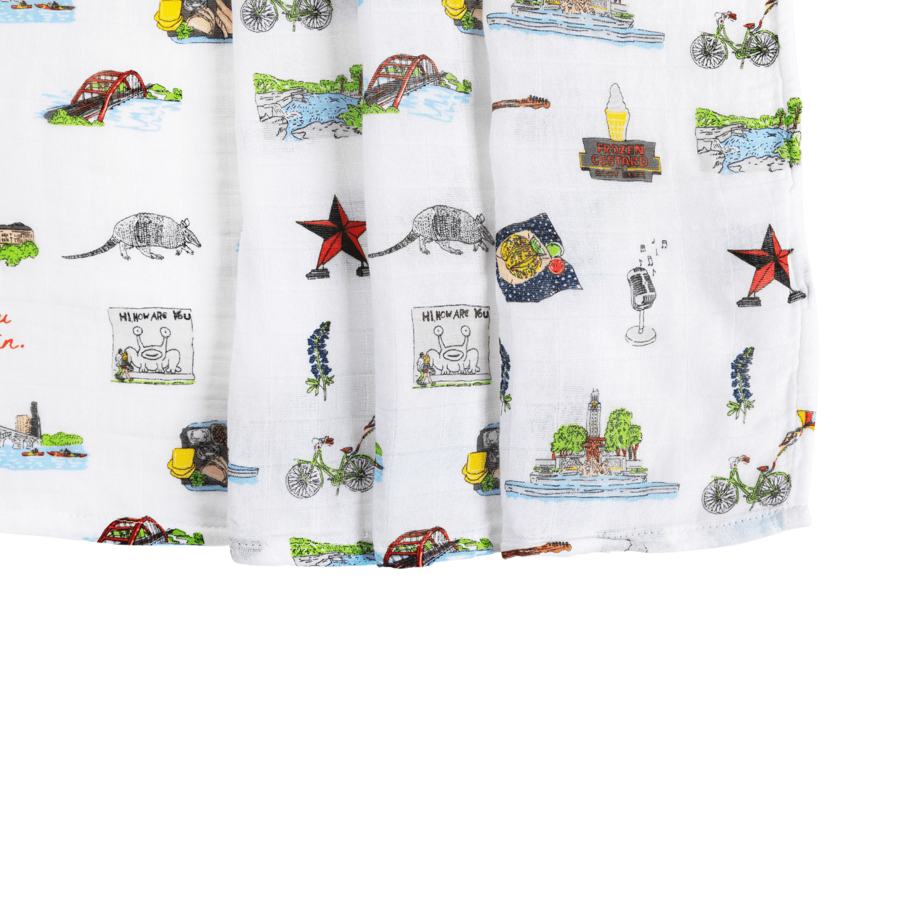 White muslin swaddle blanket with colorful Austin-themed illustrations, including landmarks, cacti, and guitars.