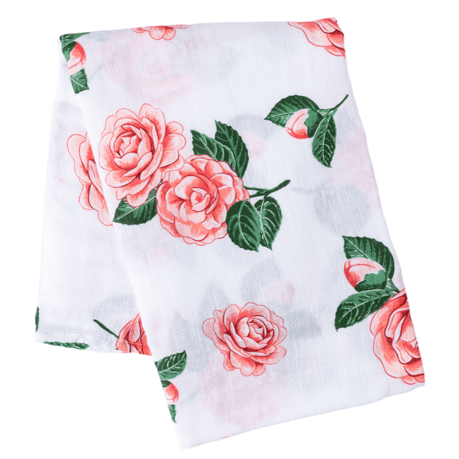 Soft muslin baby swaddle blanket with delicate pink camellia flowers, folded neatly on a white background.
