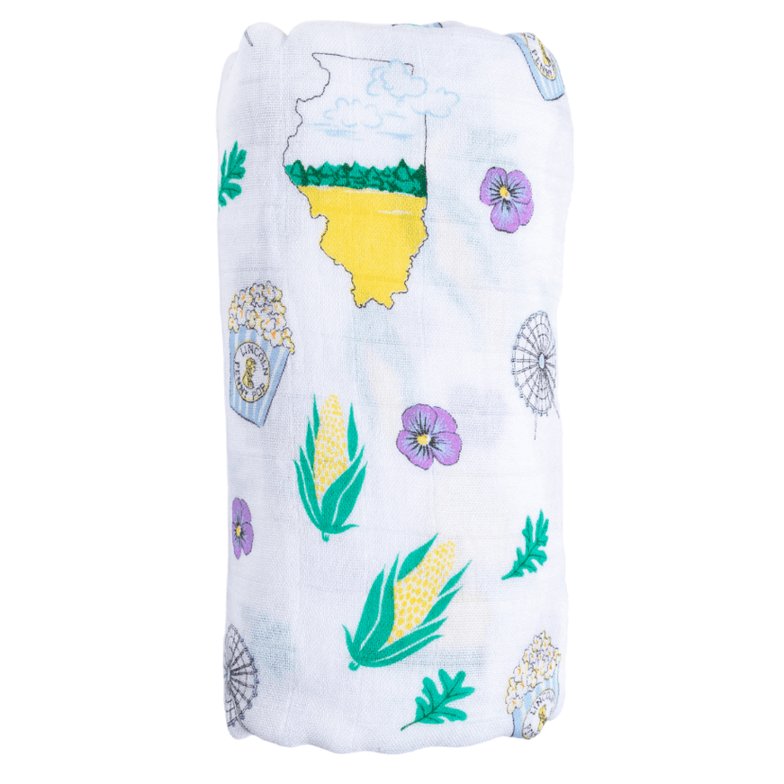 White muslin baby blanket with Illinois state icons, including Chicago skyline, corn, and state flag, on a white background.