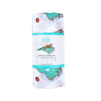 North Carolina-themed baby muslin swaddle blanket with state icons like lighthouses, cardinals, and dogwood flowers.
