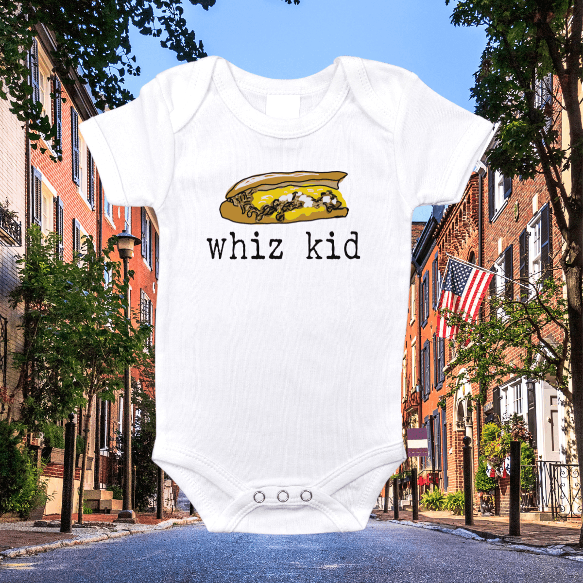 White onesie with "Philly Whiz Kid" in blue and yellow, featuring a cheesesteak graphic, on a plain background.