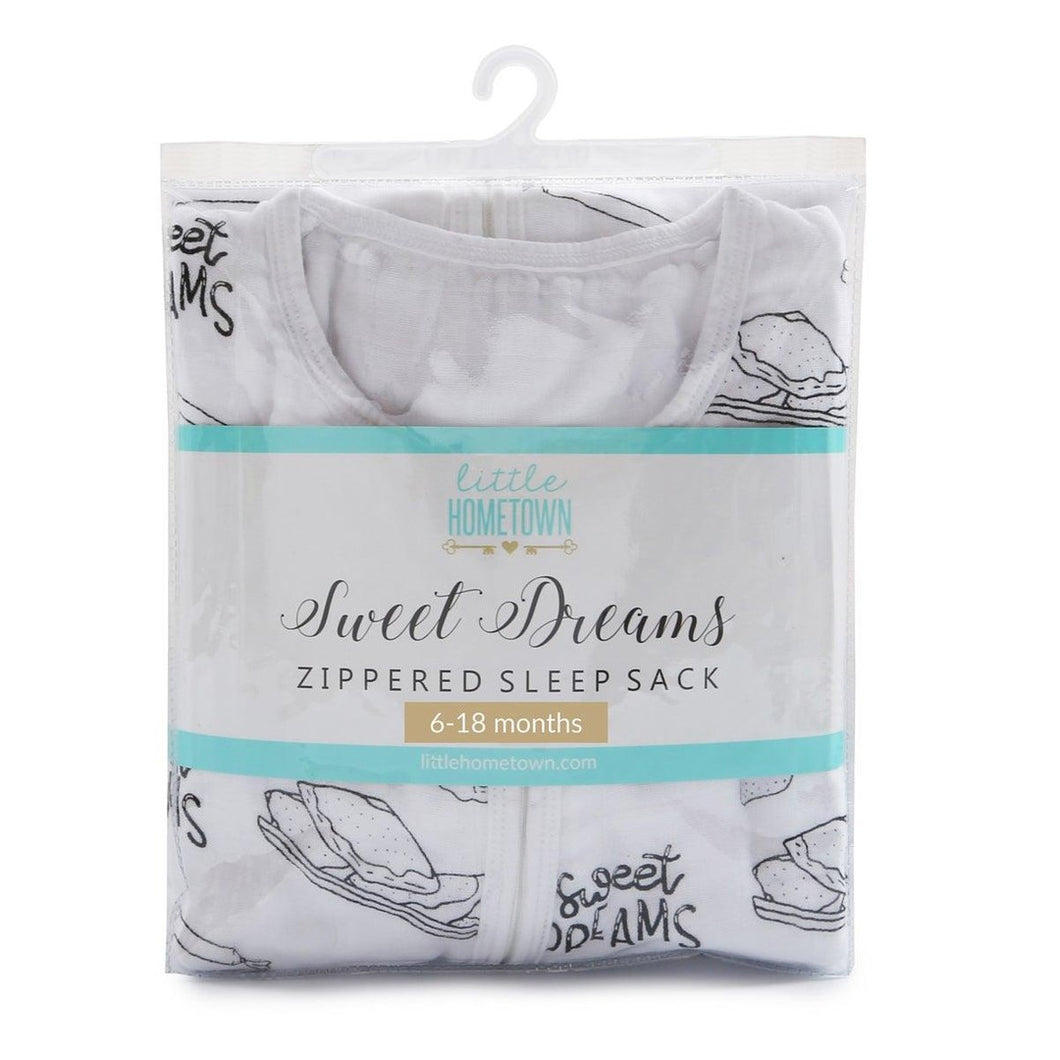 Baby in a white sleep sack with 