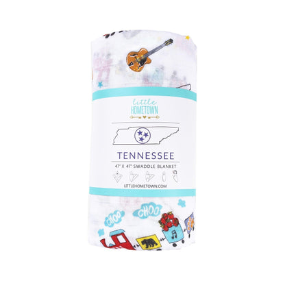 Tennessee-themed baby muslin swaddle blanket with state icons like guitars, boots, and the Tennessee flag.