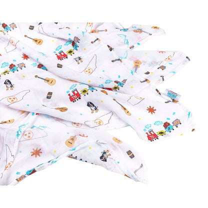 White muslin swaddle blanket with Tennessee state map, featuring landmarks, animals, and "Tennessee" text in blue.