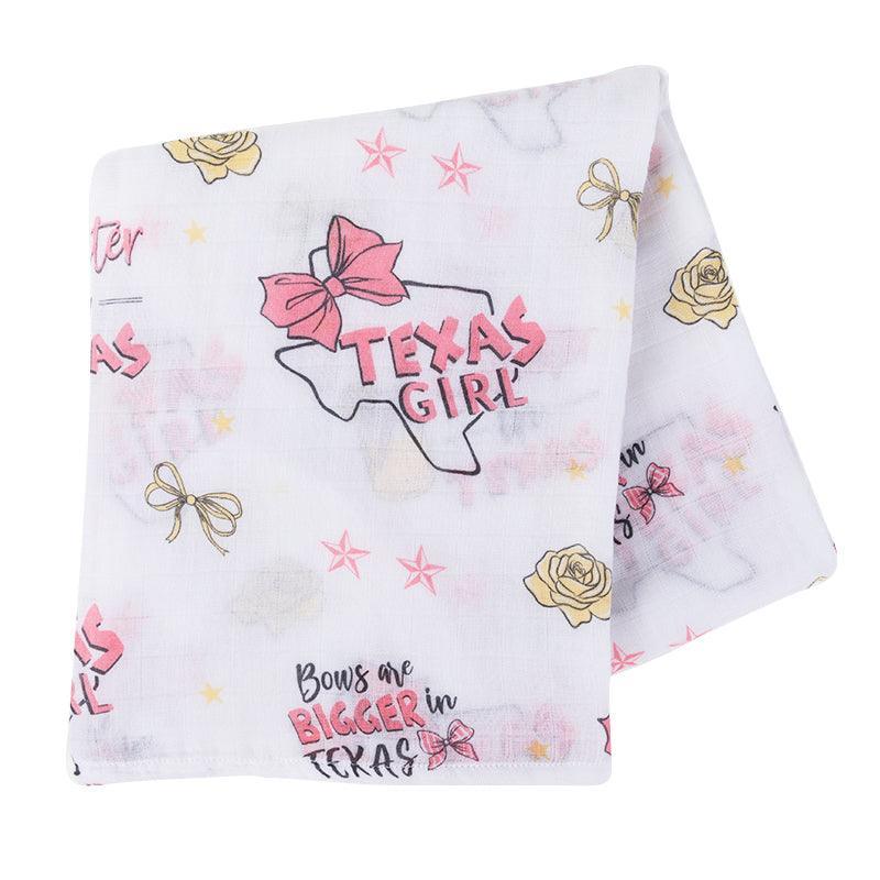 Texas-themed baby girl muslin swaddle blanket with pink accents, featuring state icons like boots and cacti.
