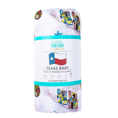White muslin swaddle blanket with Texas-themed illustrations, including cacti, cowboy boots, and state icons.
