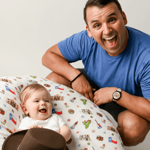 White muslin swaddle blanket with Texas-themed illustrations, including cacti, cowboy boots, and state symbols.