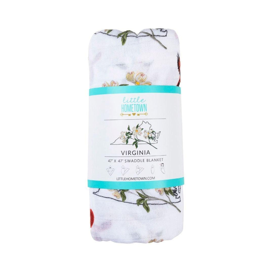 Soft muslin swaddle blanket with delicate floral pattern in pastel colors, featuring 