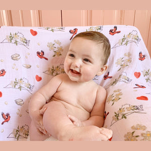Soft muslin swaddle blanket with delicate floral pattern, featuring "Virginia" text in elegant script.