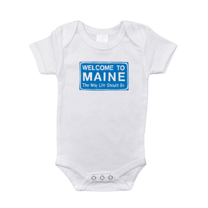 White baby onesie with "Welcome to Maine" and a lobster graphic, set against a plain background.